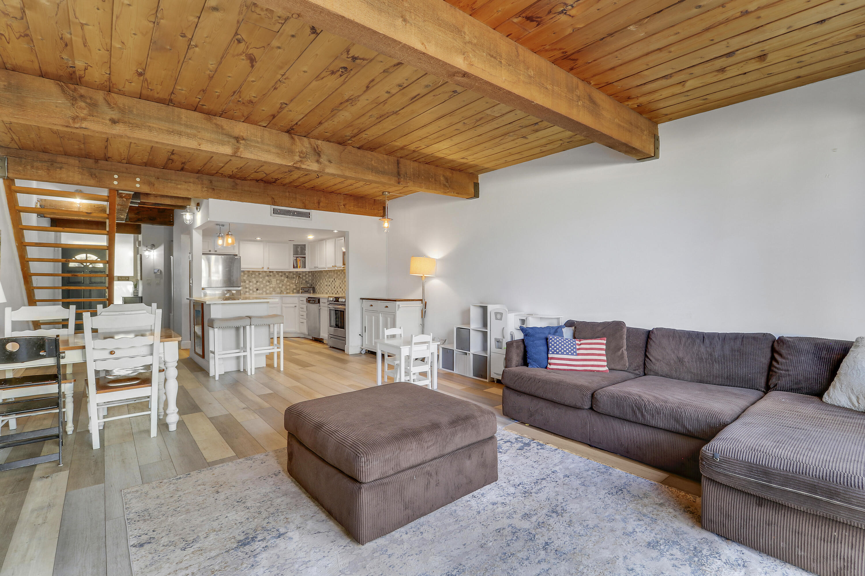4801 Northwest 2nd Avenue, Unit 101 Boca Raton, FL 33431 - Photo 13 of 31 a living room with furniture a ceiling fan and a rug