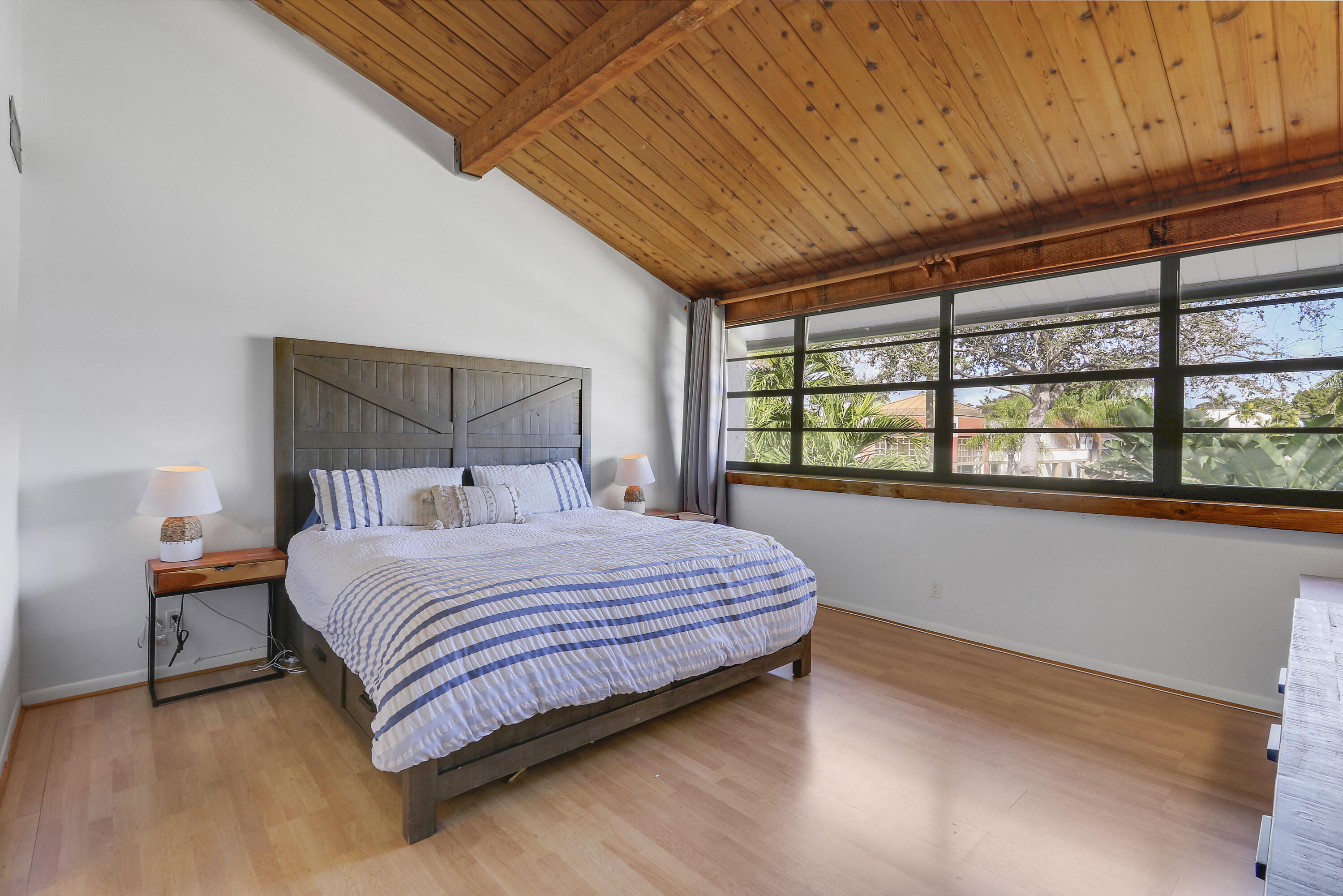 4801 Northwest 2nd Avenue, Unit 101 Boca Raton, FL 33431 - Photo 15 of 31 a bedroom with a bed and window