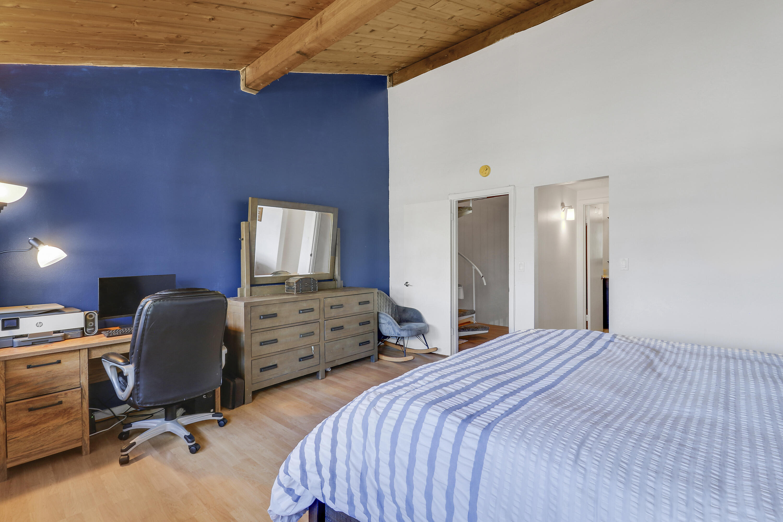 4801 Northwest 2nd Avenue, Unit 101 Boca Raton, FL 33431 - Photo 17 of 31 a bedroom with a bed and a chair