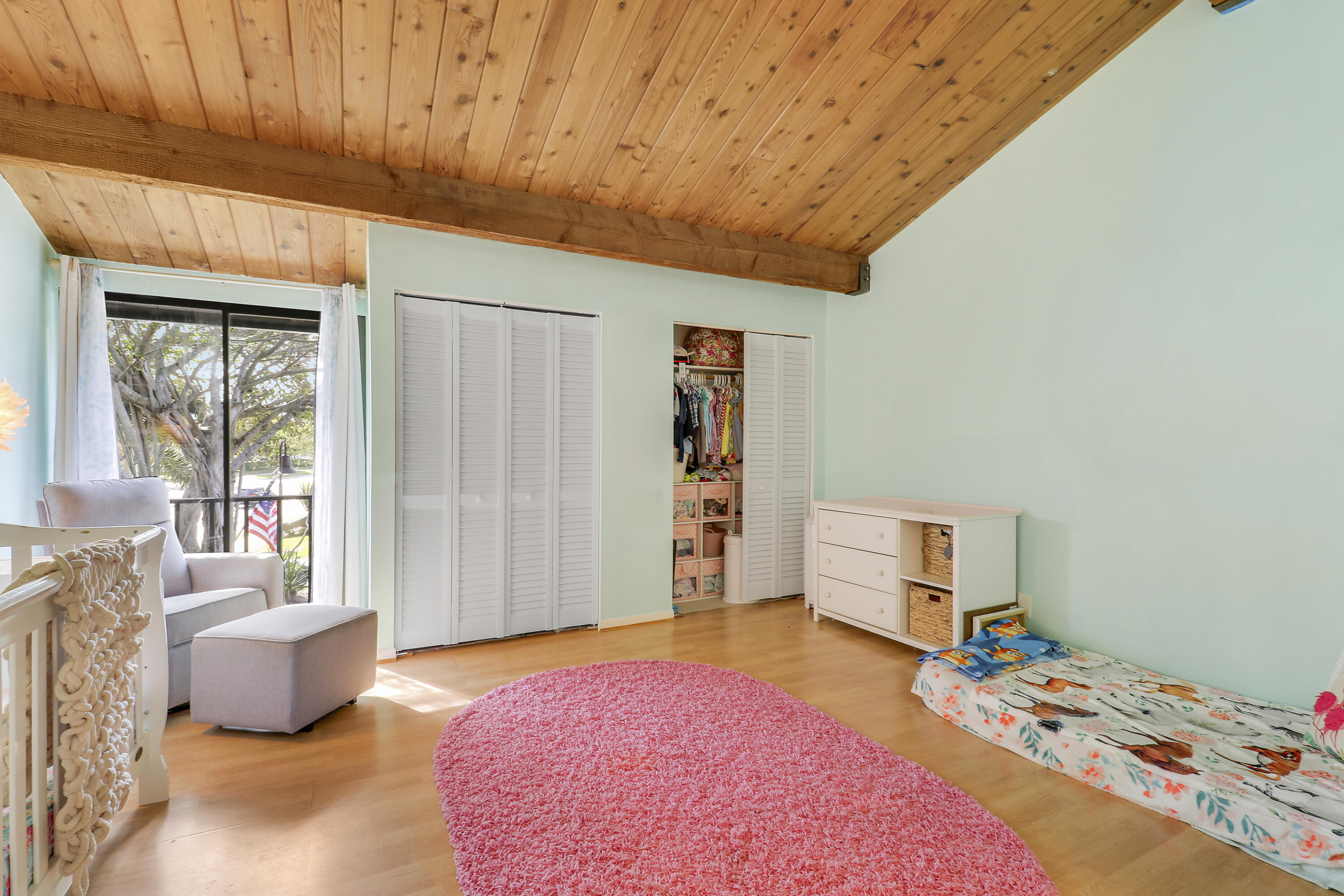 4801 Northwest 2nd Avenue, Unit 101 Boca Raton, FL 33431 - Photo 20 of 31 a bedroom with a bed and wooden floor