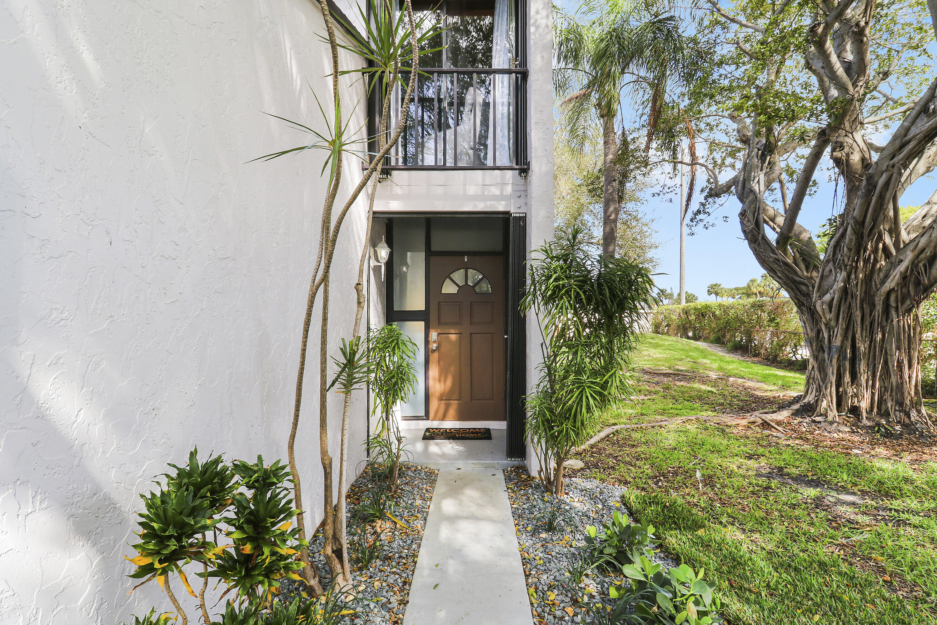 4801 Northwest 2nd Avenue, Unit 101 Boca Raton, FL 33431 - Photo 2 of 31 front view of a house with a yard