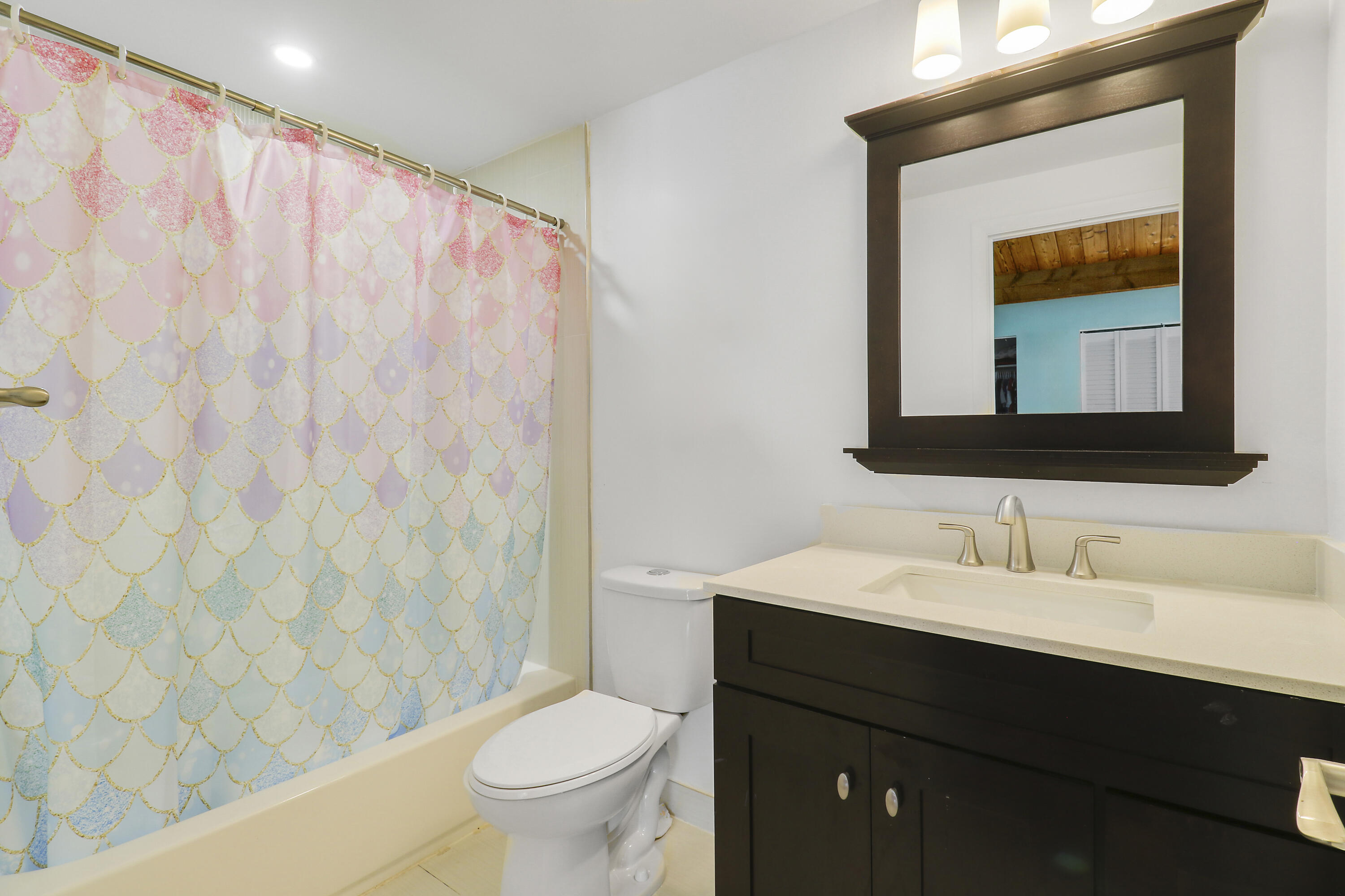 4801 Northwest 2nd Avenue, Unit 101 Boca Raton, FL 33431 - Photo 21 of 31 a bathroom with a toilet a sink and a mirror
