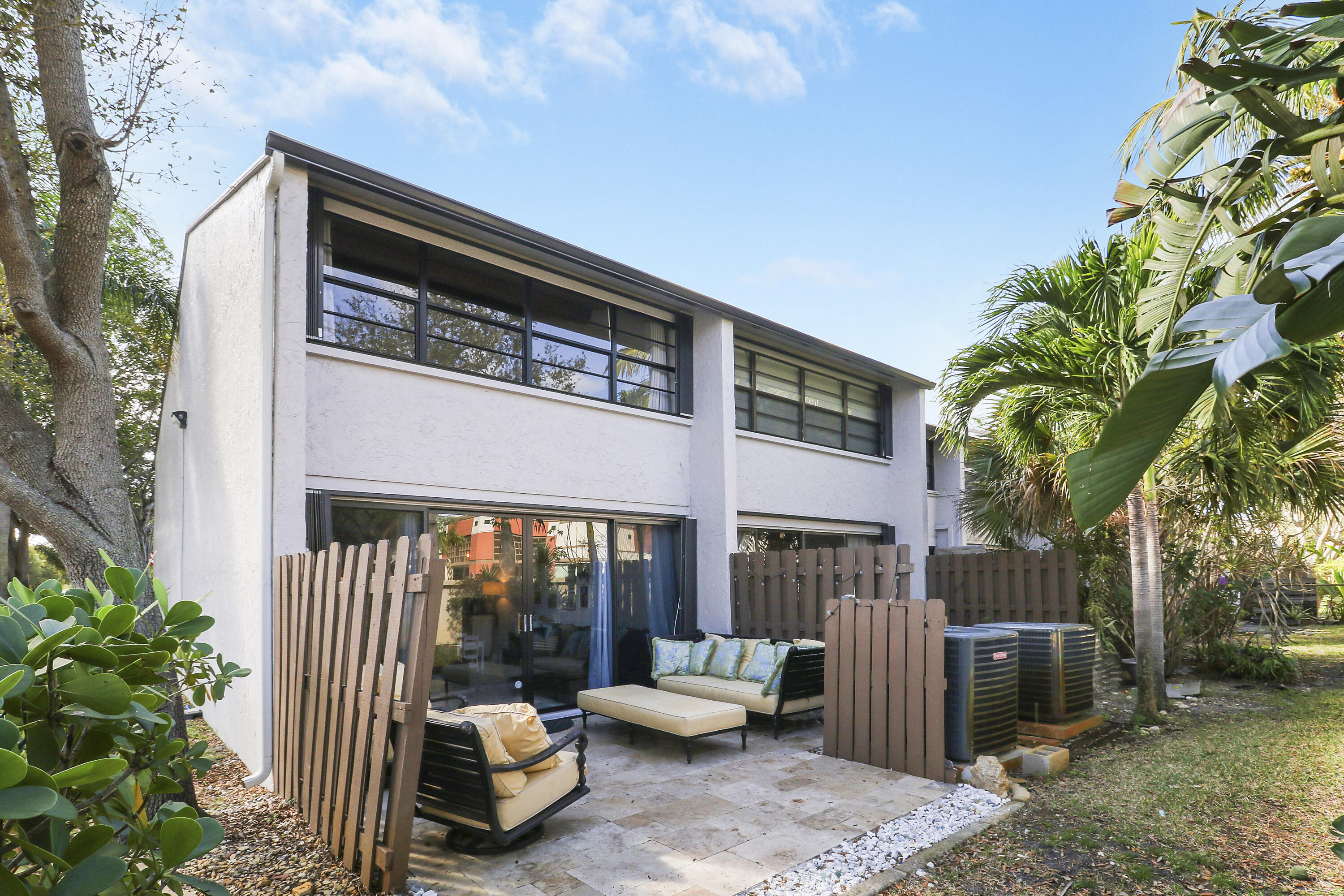 4801 Northwest 2nd Avenue, Unit 101 Boca Raton, FL 33431 - Photo 24 of 31 a backyard of a house with fountain table and chairs