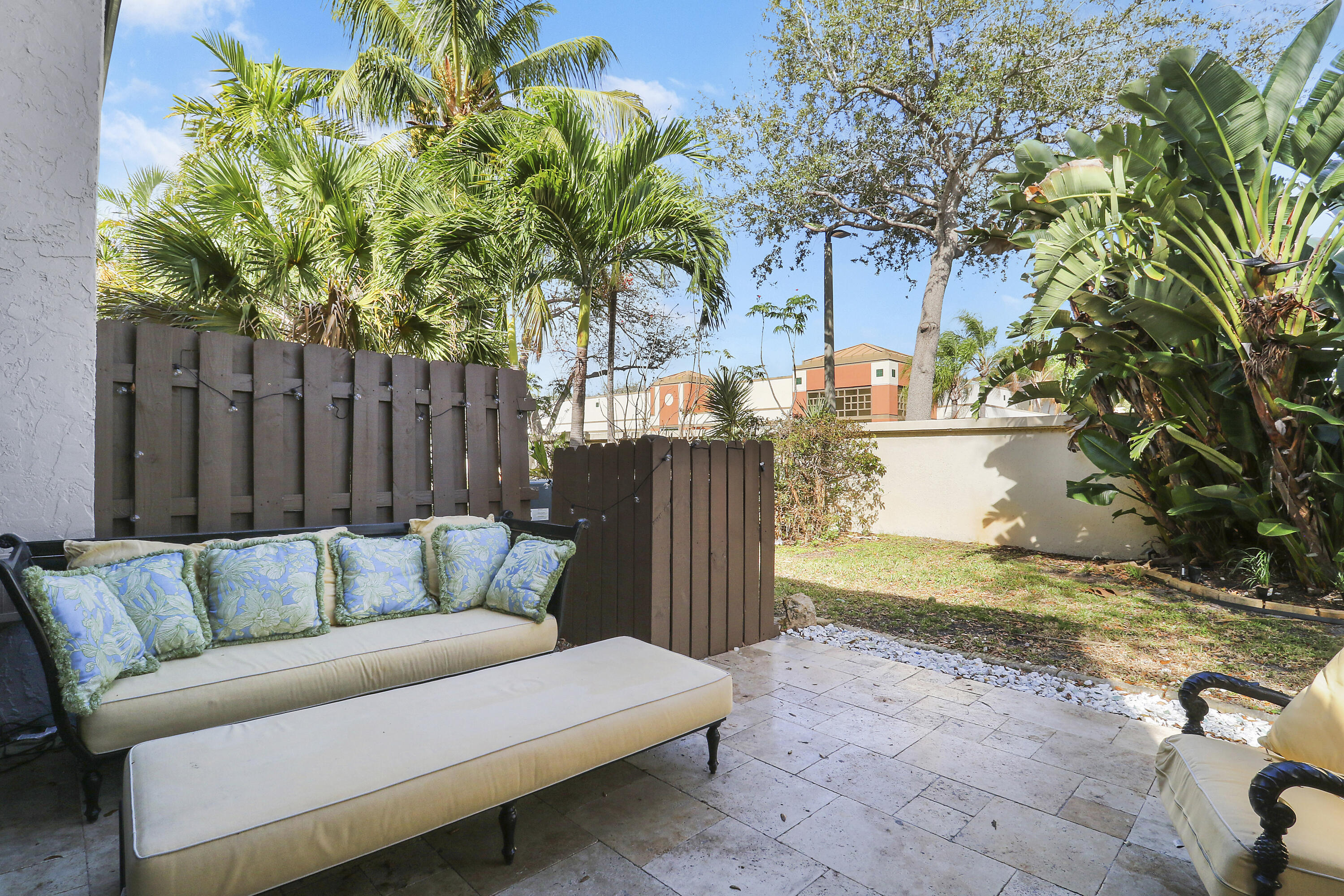 4801 Northwest 2nd Avenue, Unit 101 Boca Raton, FL 33431 - Photo 25 of 31 a backyard of a house with table and chairs