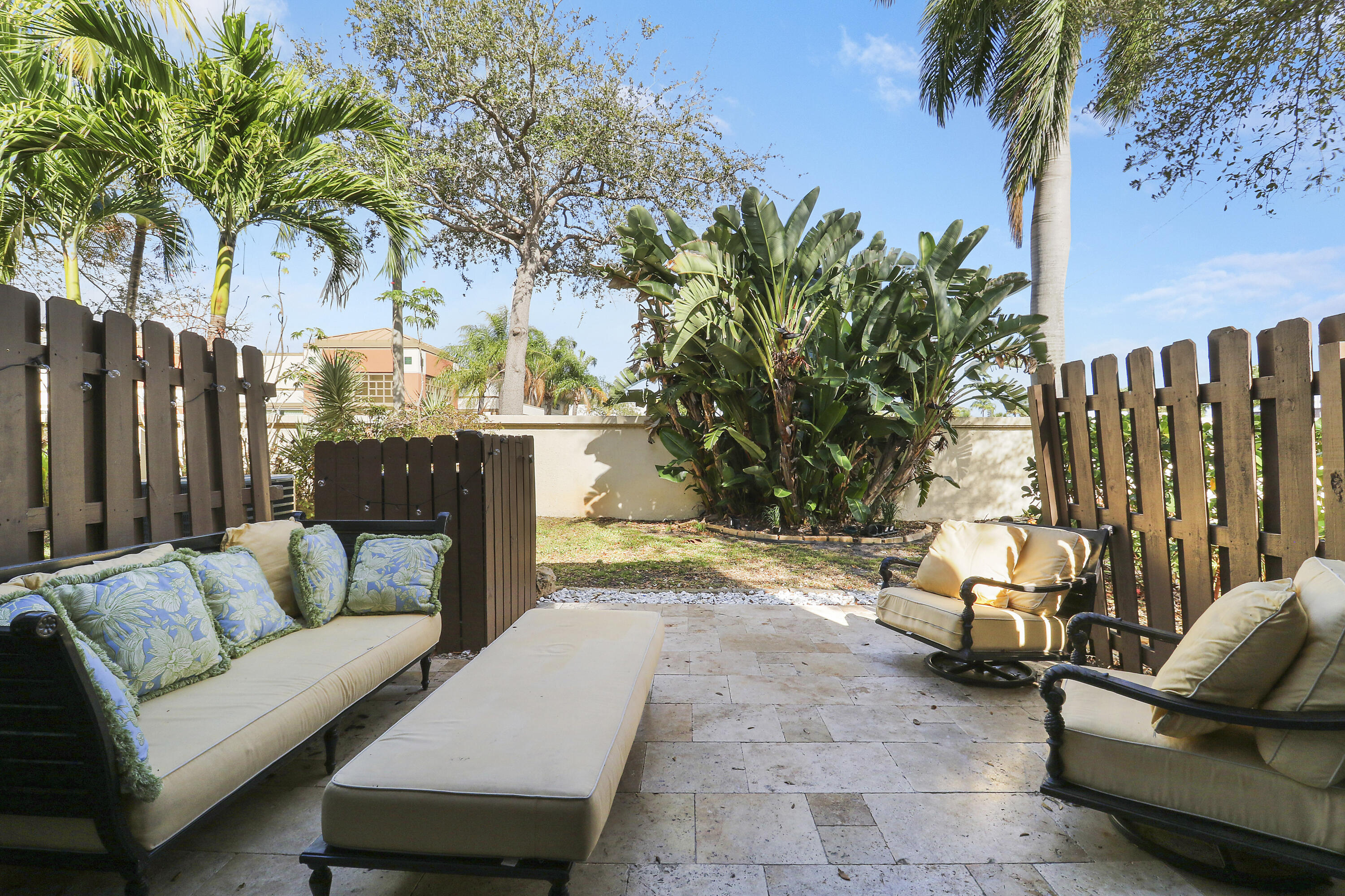4801 Northwest 2nd Avenue, Unit 101 Boca Raton, FL 33431 - Photo 26 of 31 a view of a patio with couches and a fire pit