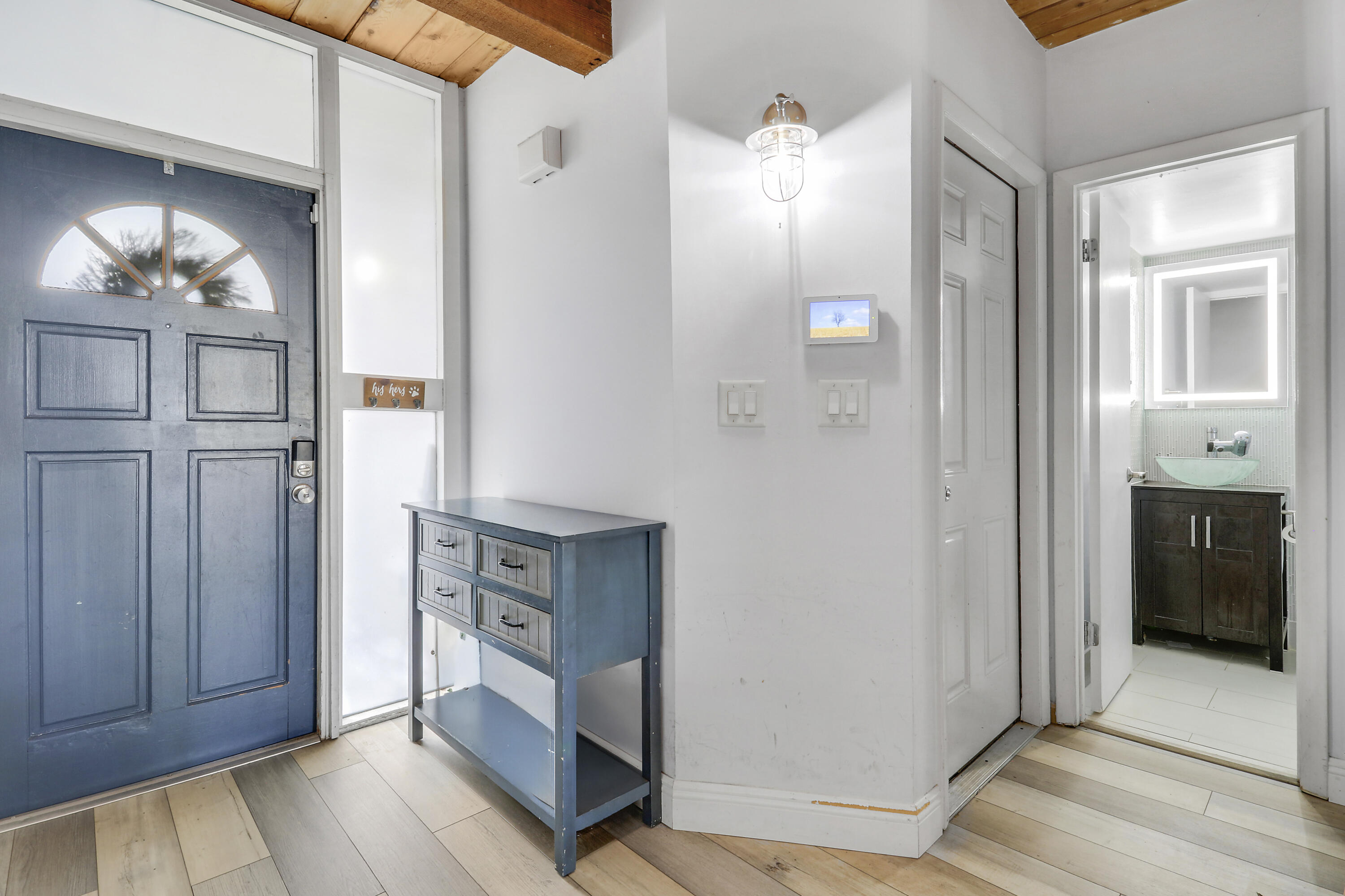 4801 Northwest 2nd Avenue, Unit 101 Boca Raton, FL 33431 - Photo 3 of 31 a view of a hallway with bathroom and wooden floor