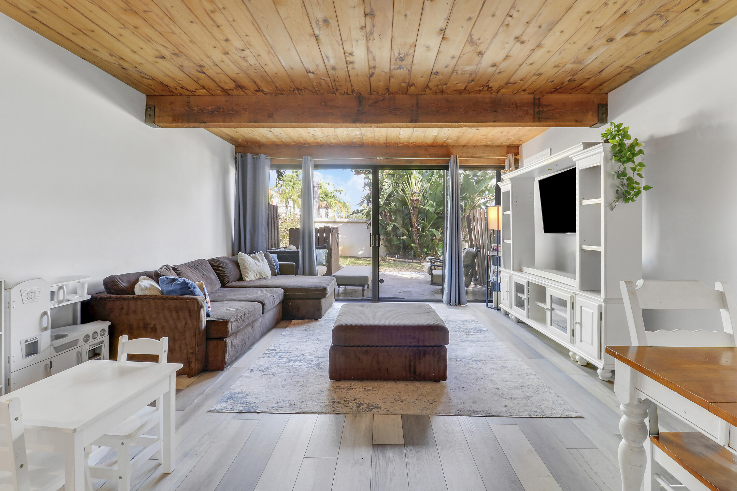 4801 Northwest 2nd Avenue, Unit 101 Boca Raton, FL 33431 - Photo 8 of 31 a living room with furniture and a flat screen tv
