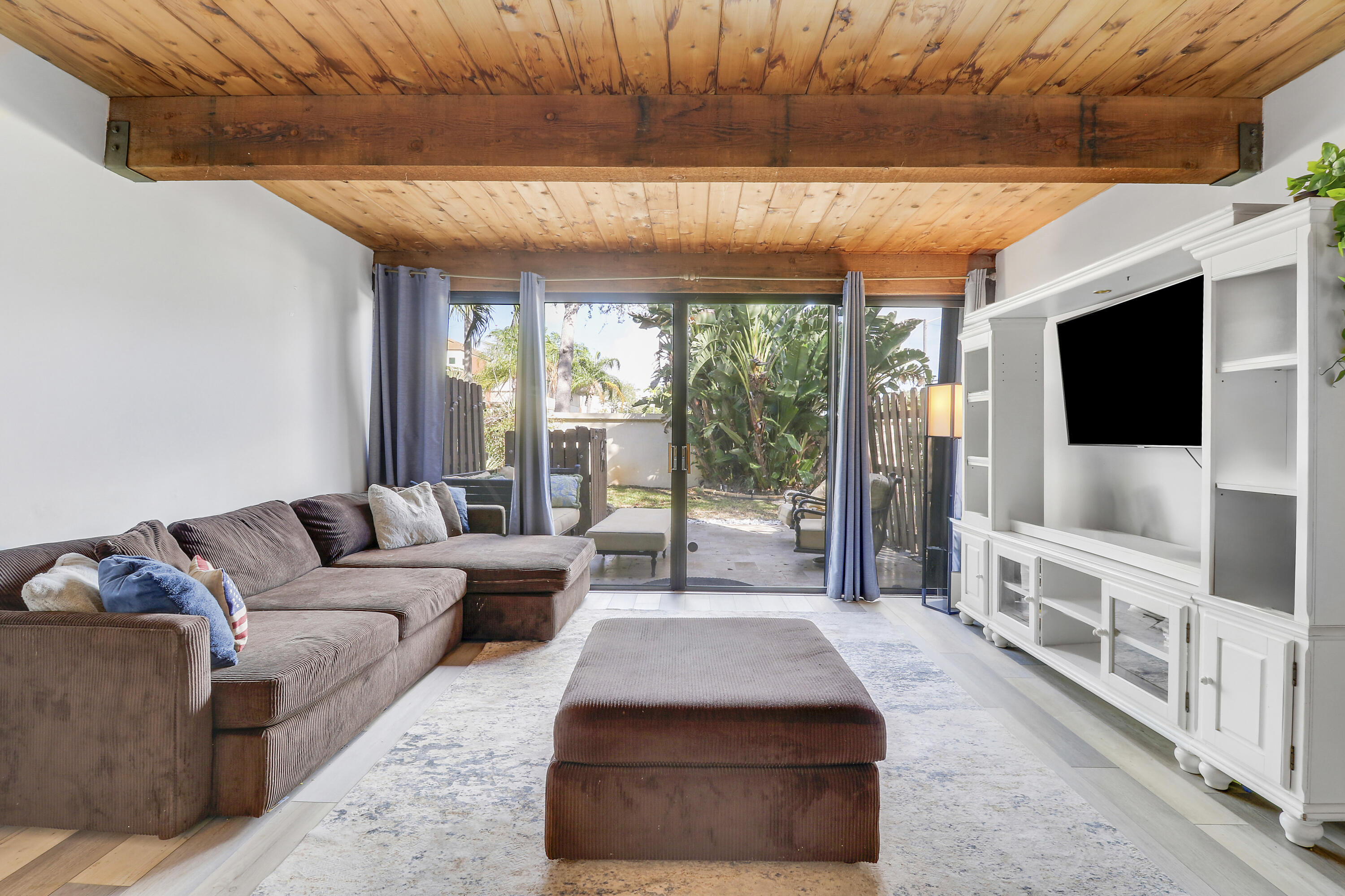 4801 Northwest 2nd Avenue, Unit 101 Boca Raton, FL 33431 - Photo 10 of 31 a living room with furniture and a flat screen tv