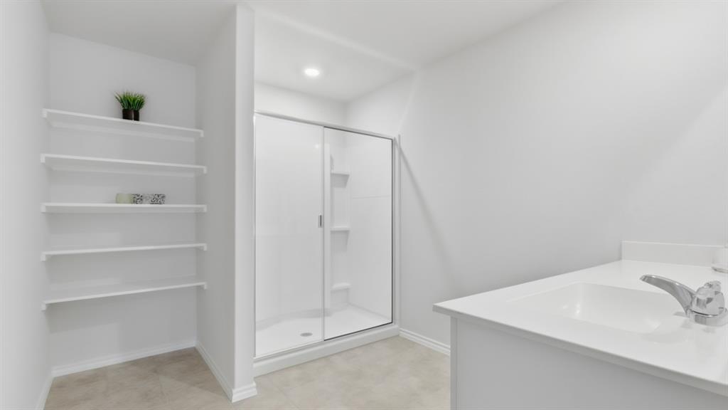 2820 Hawk Drive Denton, TX 76205 - Photo 8 of 30 a bathroom with a sink and shower