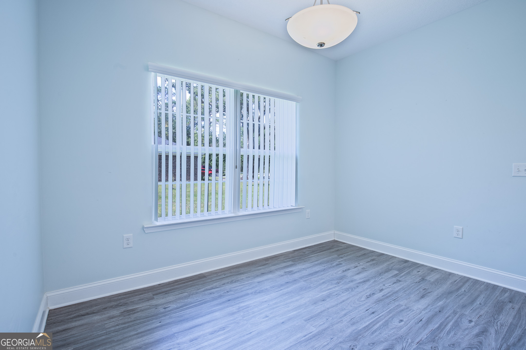 3453 John Wells Road Ludowici, GA 31316 - Photo 21 of 51 a view of an empty room with wooden floor and a window