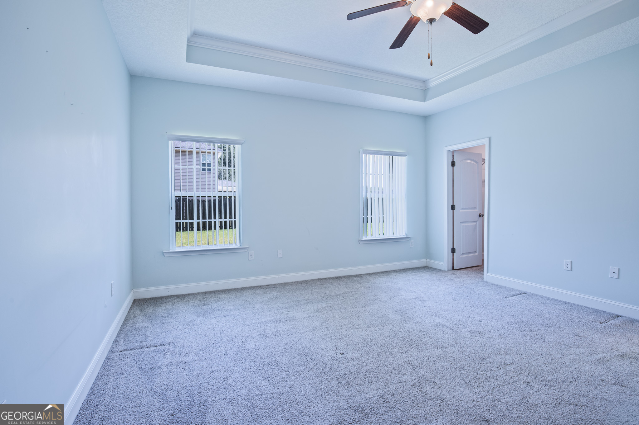 3453 John Wells Road Ludowici, GA 31316 - Photo 35 of 51 an empty room with a ceiling fan and windows
