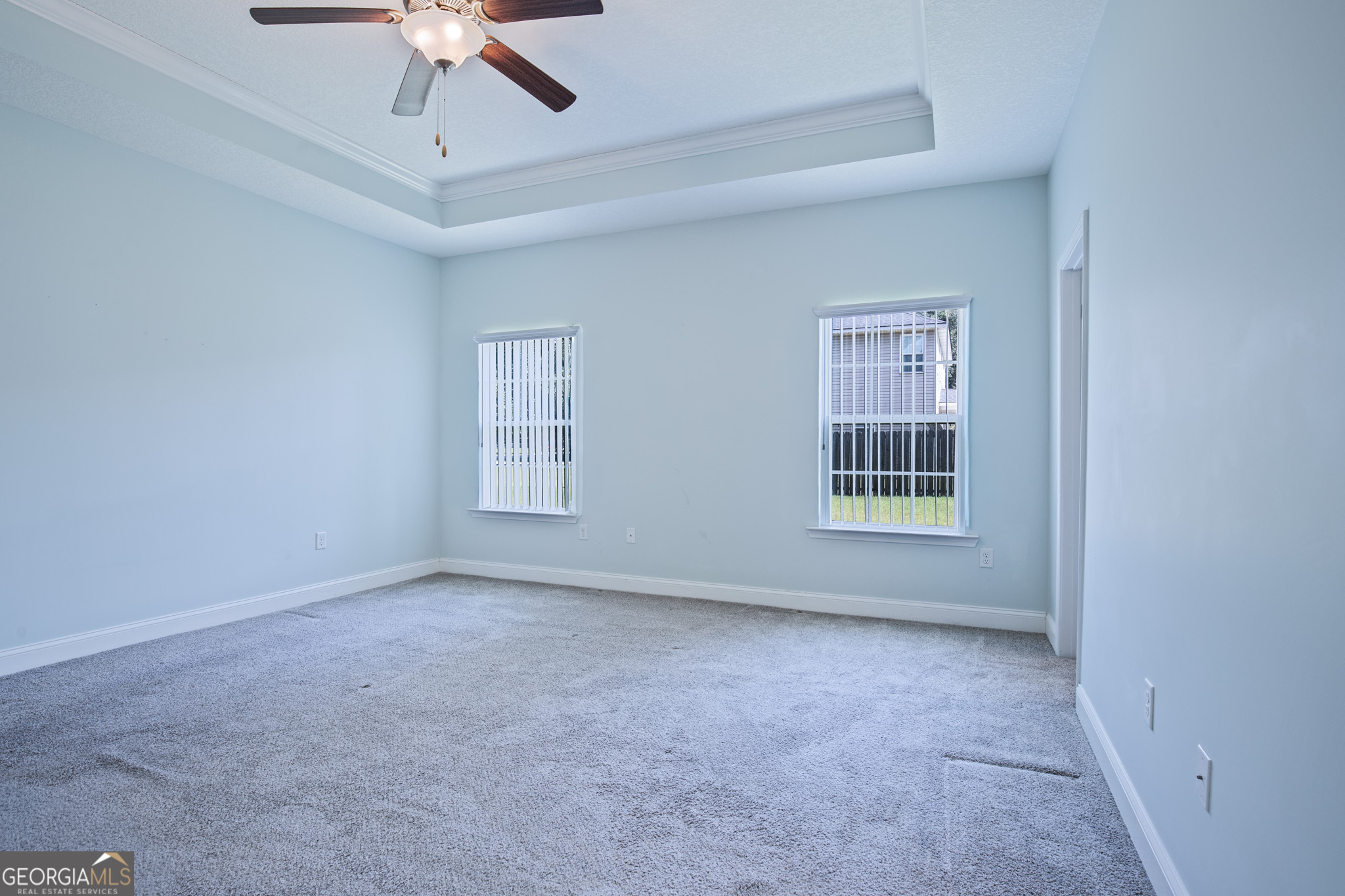 3453 John Wells Road Ludowici, GA 31316 - Photo 36 of 51 an empty room with a ceiling fan and windows