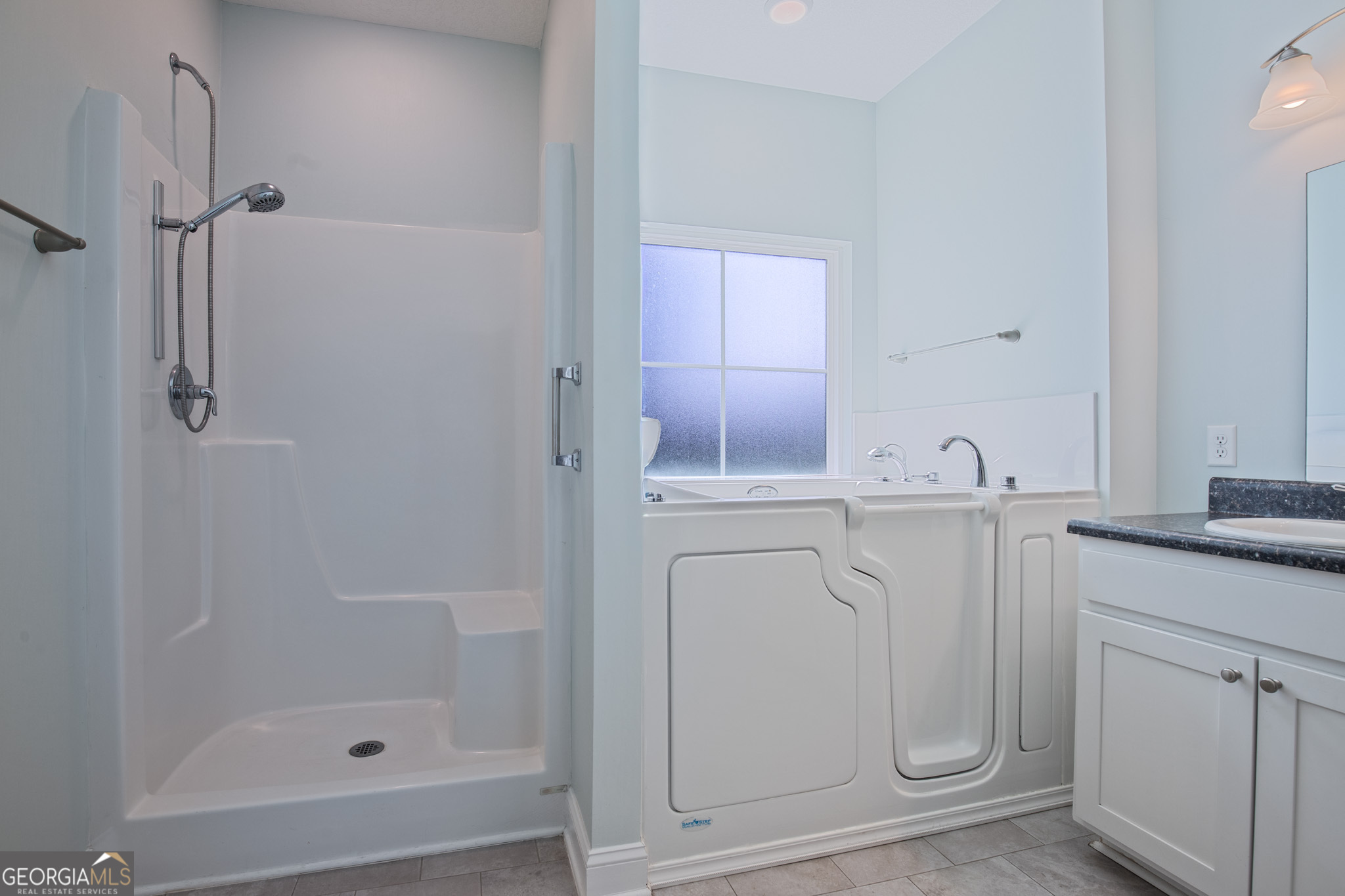 3453 John Wells Road Ludowici, GA 31316 - Photo 40 of 51 a bathroom with a shower sink and mirror