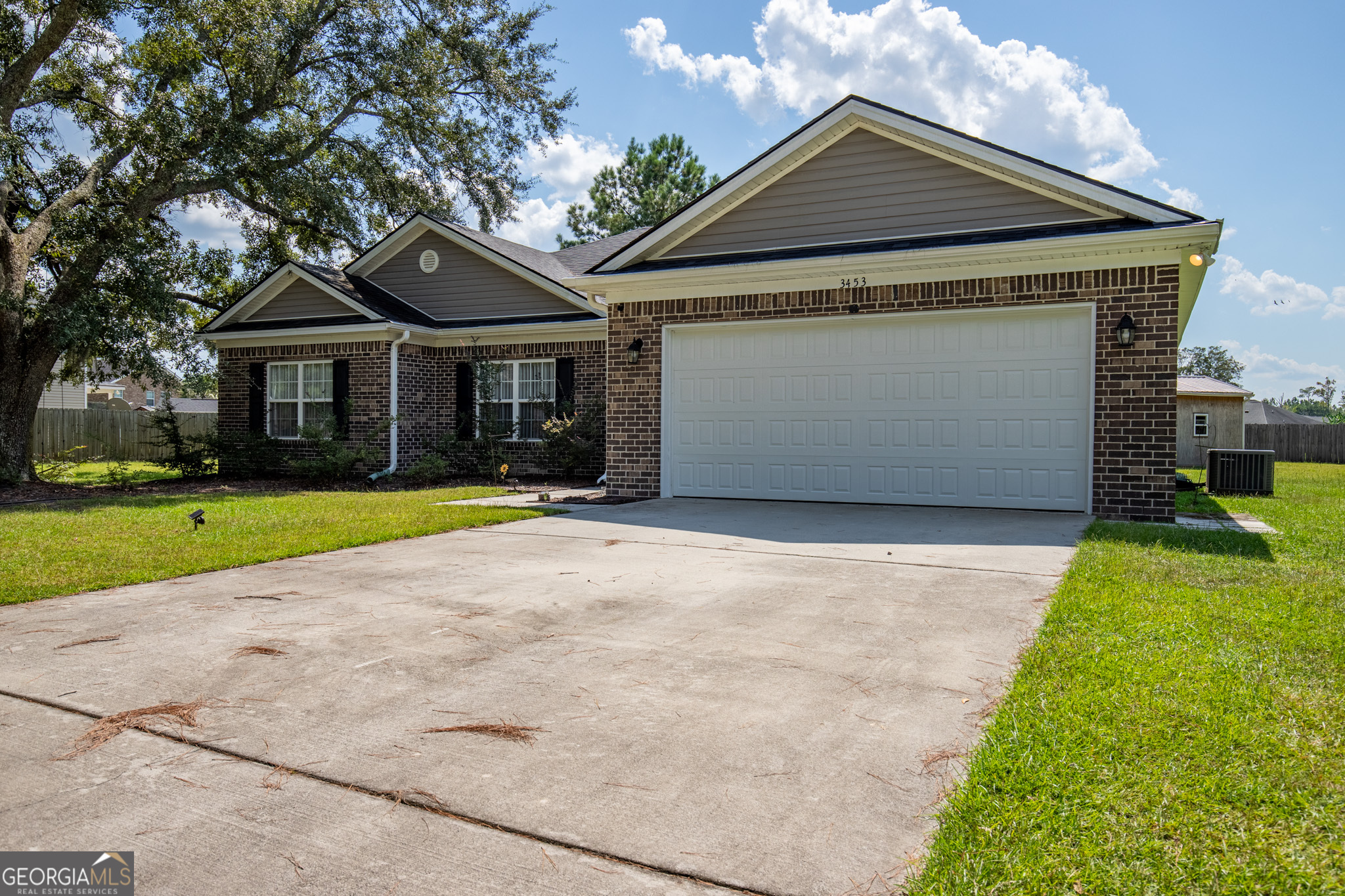 3453 John Wells Road Ludowici, GA 31316 - Photo 9 of 51 a front view of a house with a yard and garage