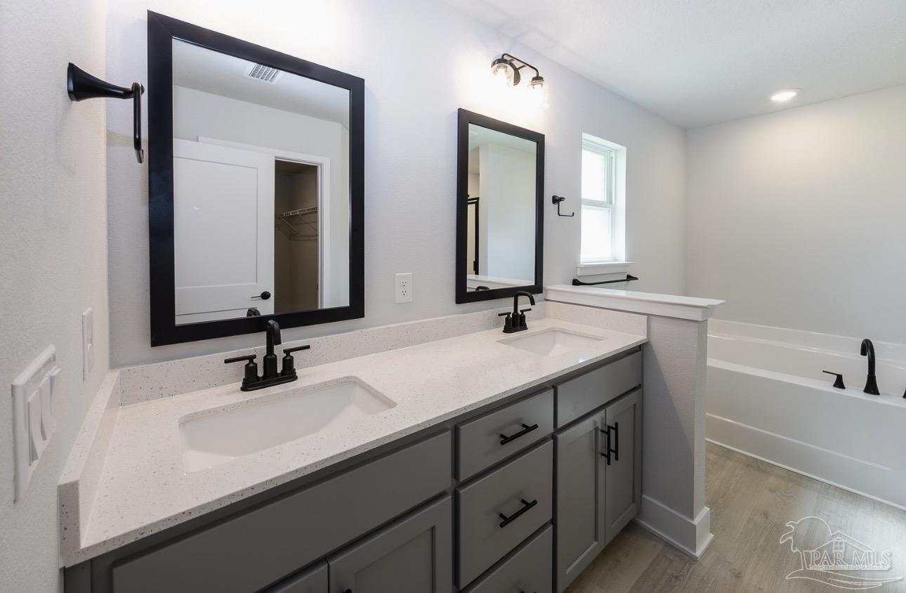 7657 Small Pnes Street Milton, FL 32583 - Photo 15 of 26 a bathroom with double vanity sinks and a mirror