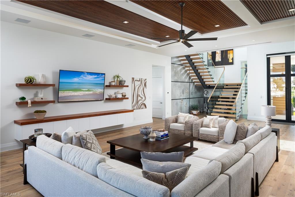 441 Mooring Line Drive Naples, FL 34102 - Photo 16 of 50 a living room with furniture and a flat screen tv