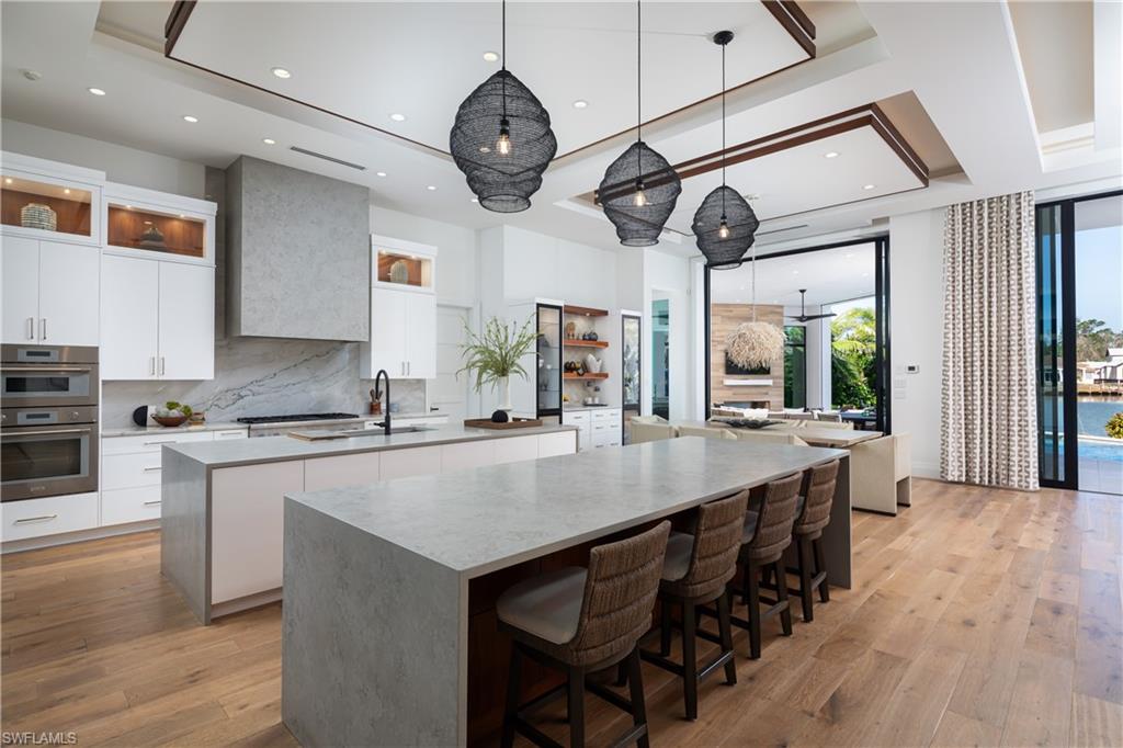 441 Mooring Line Drive Naples, FL 34102 - Photo 18 of 50 a large kitchen with a table and chairs
