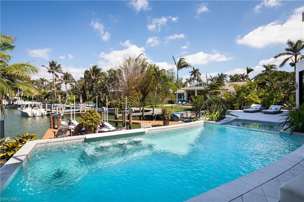 441 Mooring Line Drive Naples, FL 34102 - Photo 24 of 50 a view of a swimming pool with a lake view