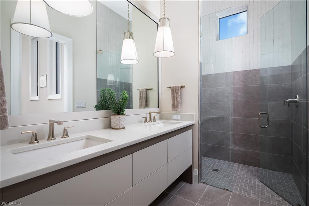 441 Mooring Line Drive Naples, FL 34102 - Photo 30 of 50 a bathroom with a double vanity sink mirror and shower