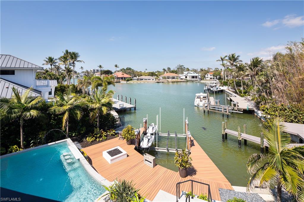 441 Mooring Line Drive Naples, FL 34102 - Photo 3 of 50 a view of a balcony with chairs and wooden floor
