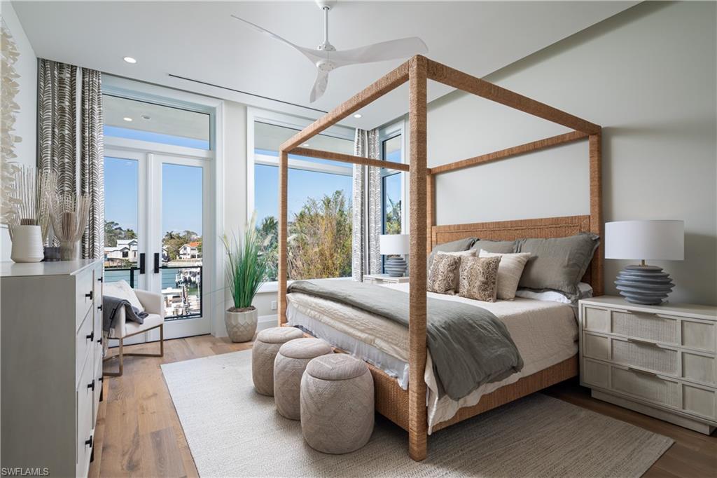 441 Mooring Line Drive Naples, FL 34102 - Photo 34 of 50 a bedroom with a bed and a couch