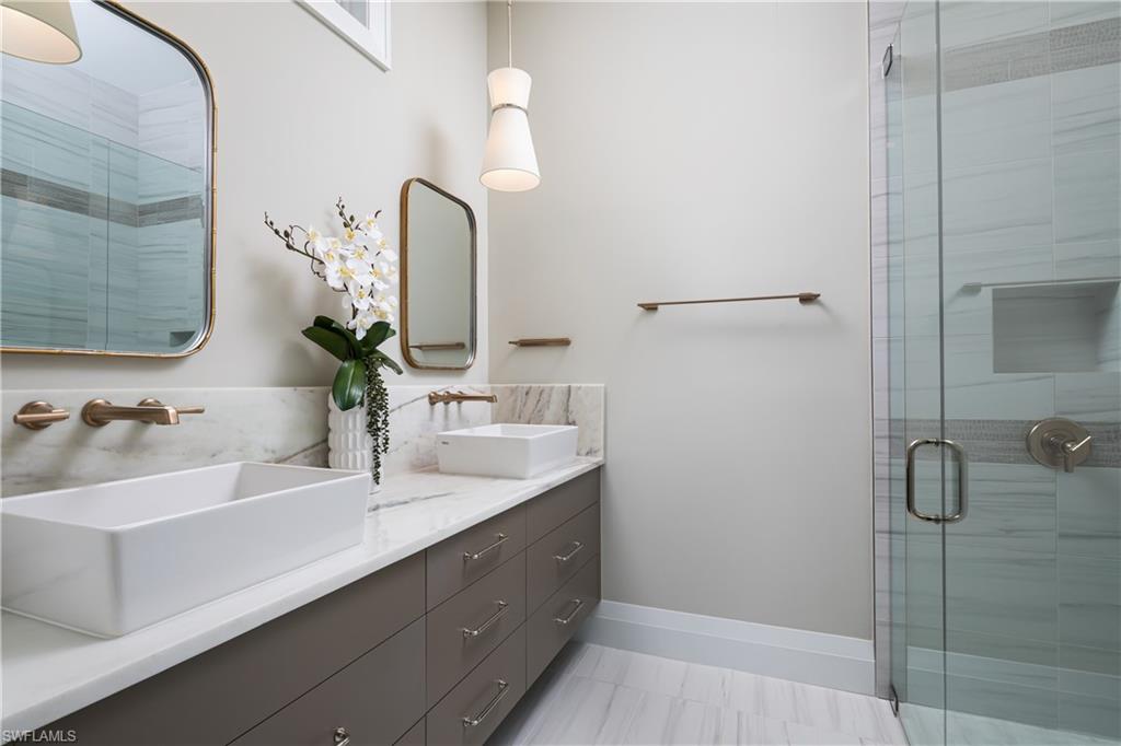 441 Mooring Line Drive Naples, FL 34102 - Photo 35 of 50 a bathroom with a double vanity sink and a mirror