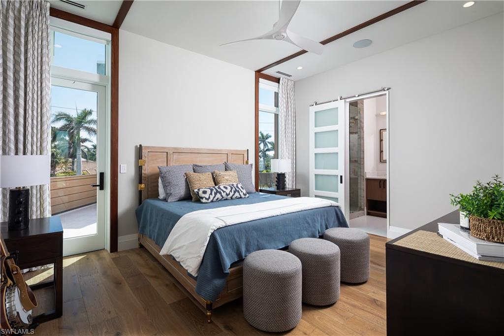441 Mooring Line Drive Naples, FL 34102 - Photo 36 of 50 a bedroom with furniture a bed and a flat screen tv