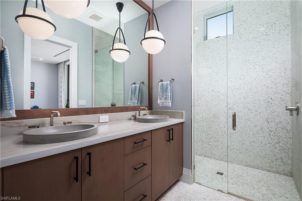 441 Mooring Line Drive Naples, FL 34102 - Photo 39 of 50 a bathroom with a double vanity sink and a mirror