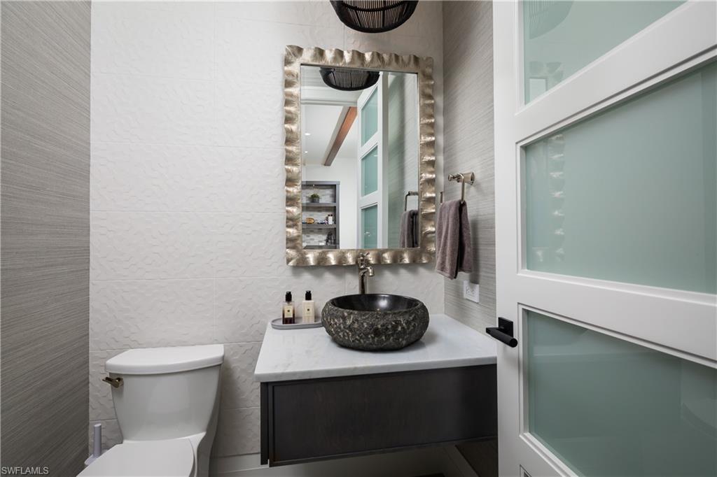 441 Mooring Line Drive Naples, FL 34102 - Photo 44 of 50 a bathroom with a toilet and a sink
