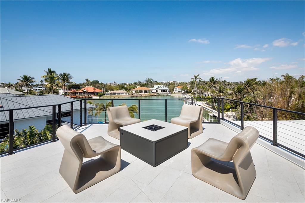 441 Mooring Line Drive Naples, FL 34102 - Photo 45 of 50 a view of a roof deck with couches and potted plants