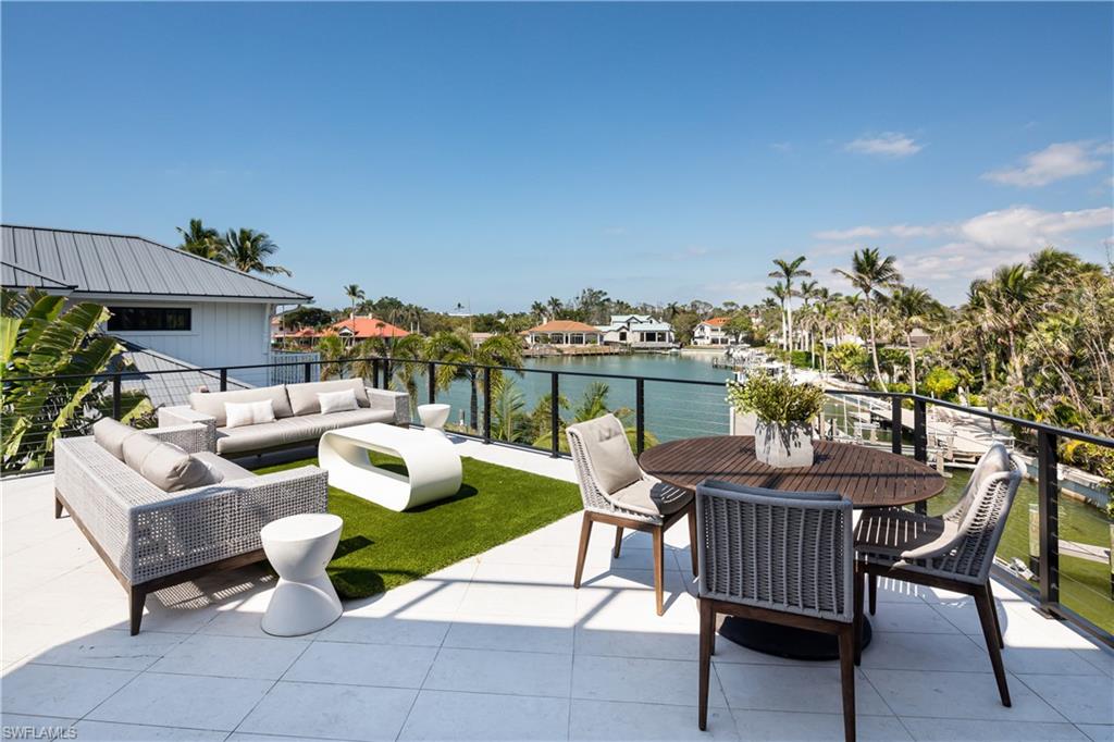 441 Mooring Line Drive Naples, FL 34102 - Photo 46 of 50 a view of a patio with couches and potted plants
