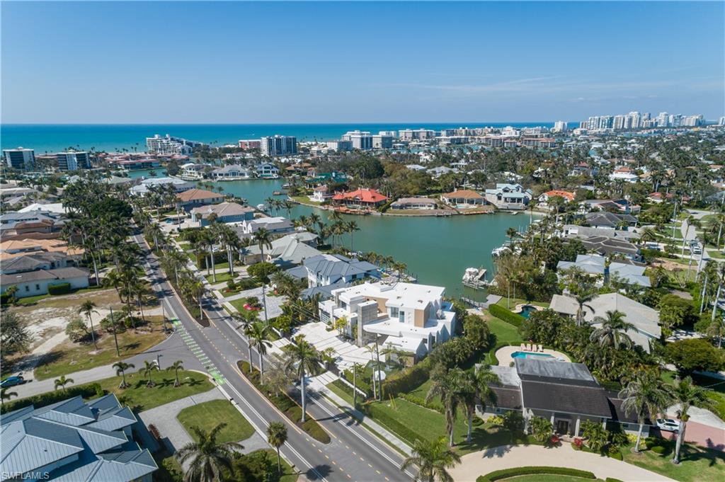 441 Mooring Line Drive Naples, FL 34102 - Photo 50 of 50 an aerial view of a city with lots of residential buildings ocean and mountain view in back