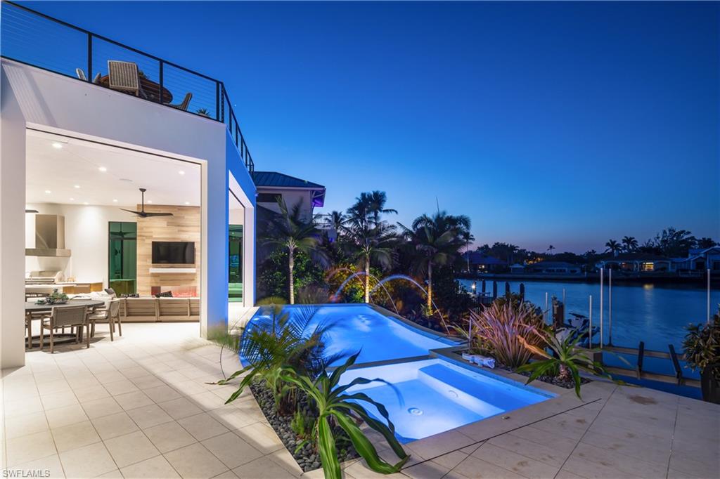 441 Mooring Line Drive Naples, FL 34102 - Photo 9 of 50 a view of a chairs and table in the patio