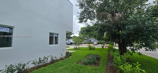 a view of a house with a backyard