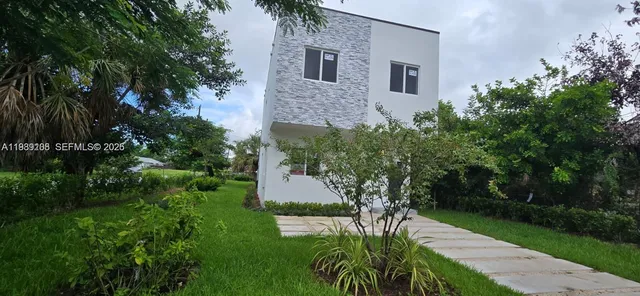 a aerial view of a house with a yard and potted plants