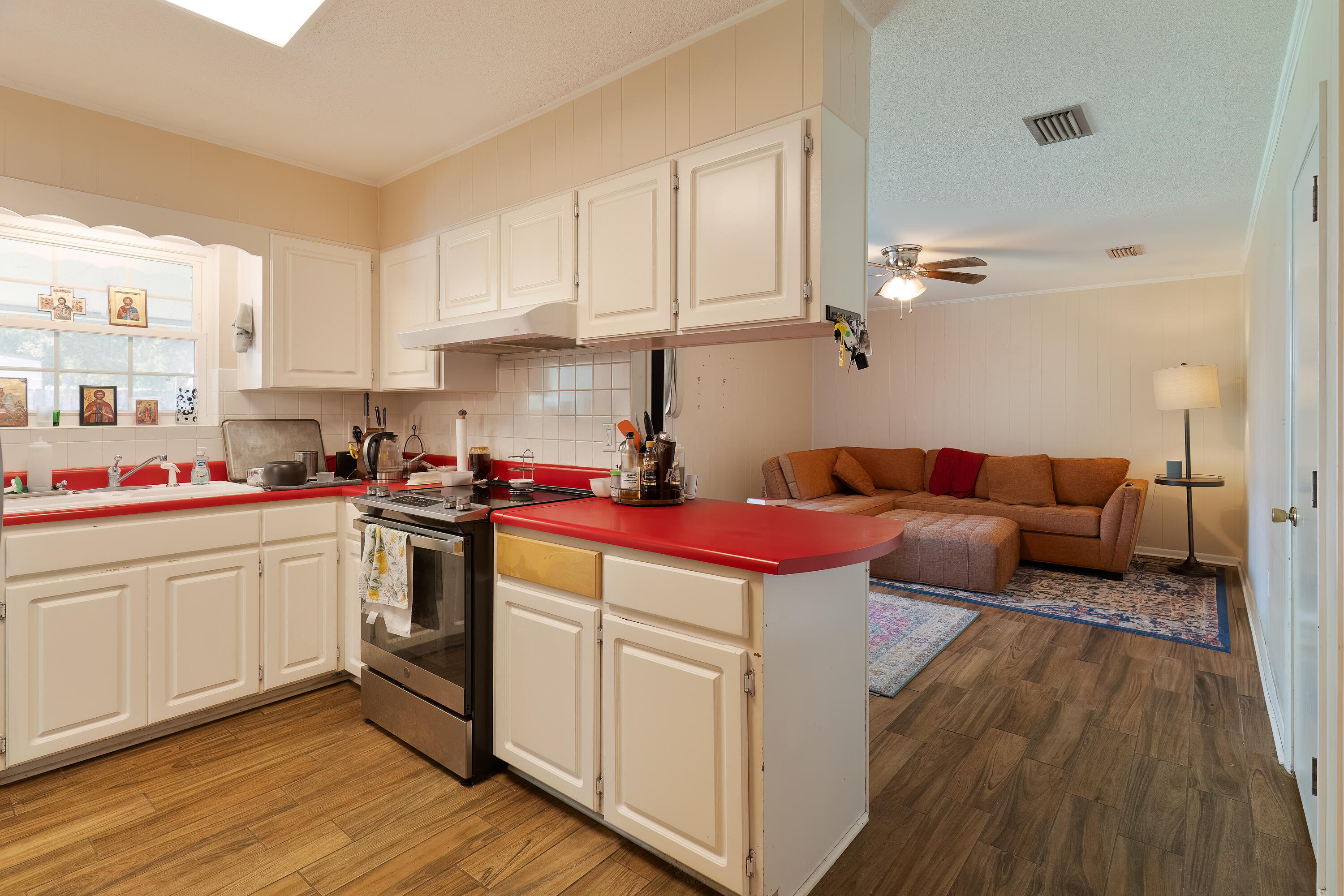 35 James Avenue Shalimar, FL 32579 - Photo 12 of 44 a kitchen with a stove cabinets and wooden floor