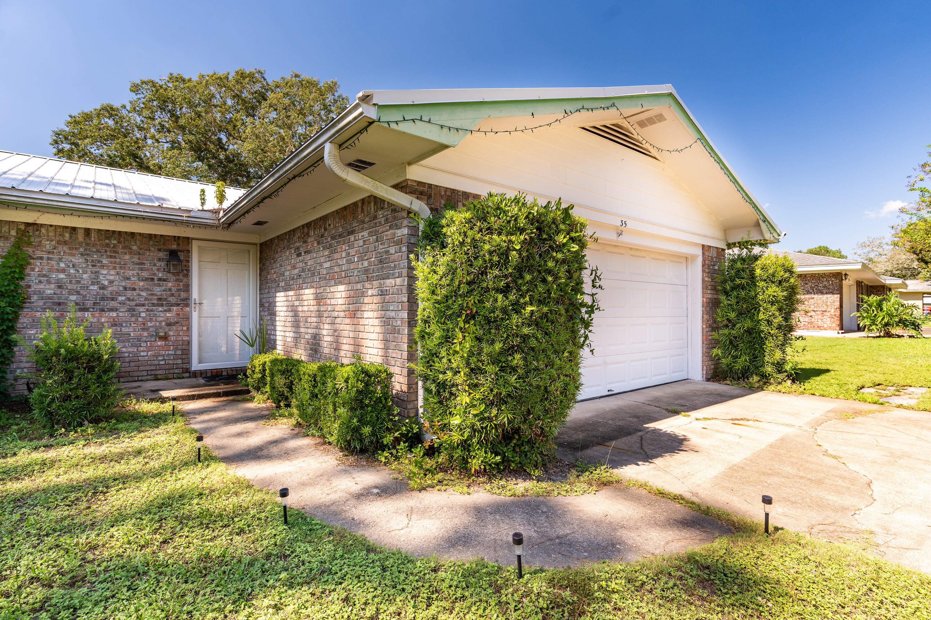35 James Avenue Shalimar, FL 32579 - Photo 26 of 44 a view of a house with a yard and plants