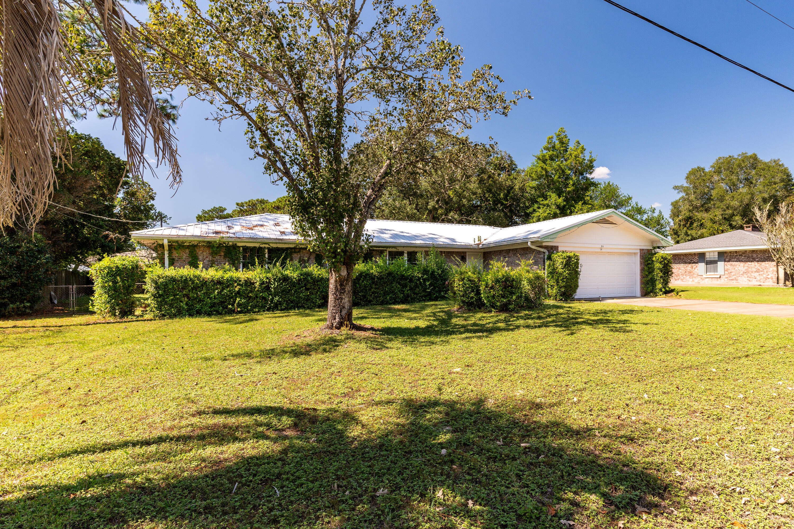 35 James Avenue Shalimar, FL 32579 - Photo 28 of 44 a view of a swimming pool with an outdoor space and seating area