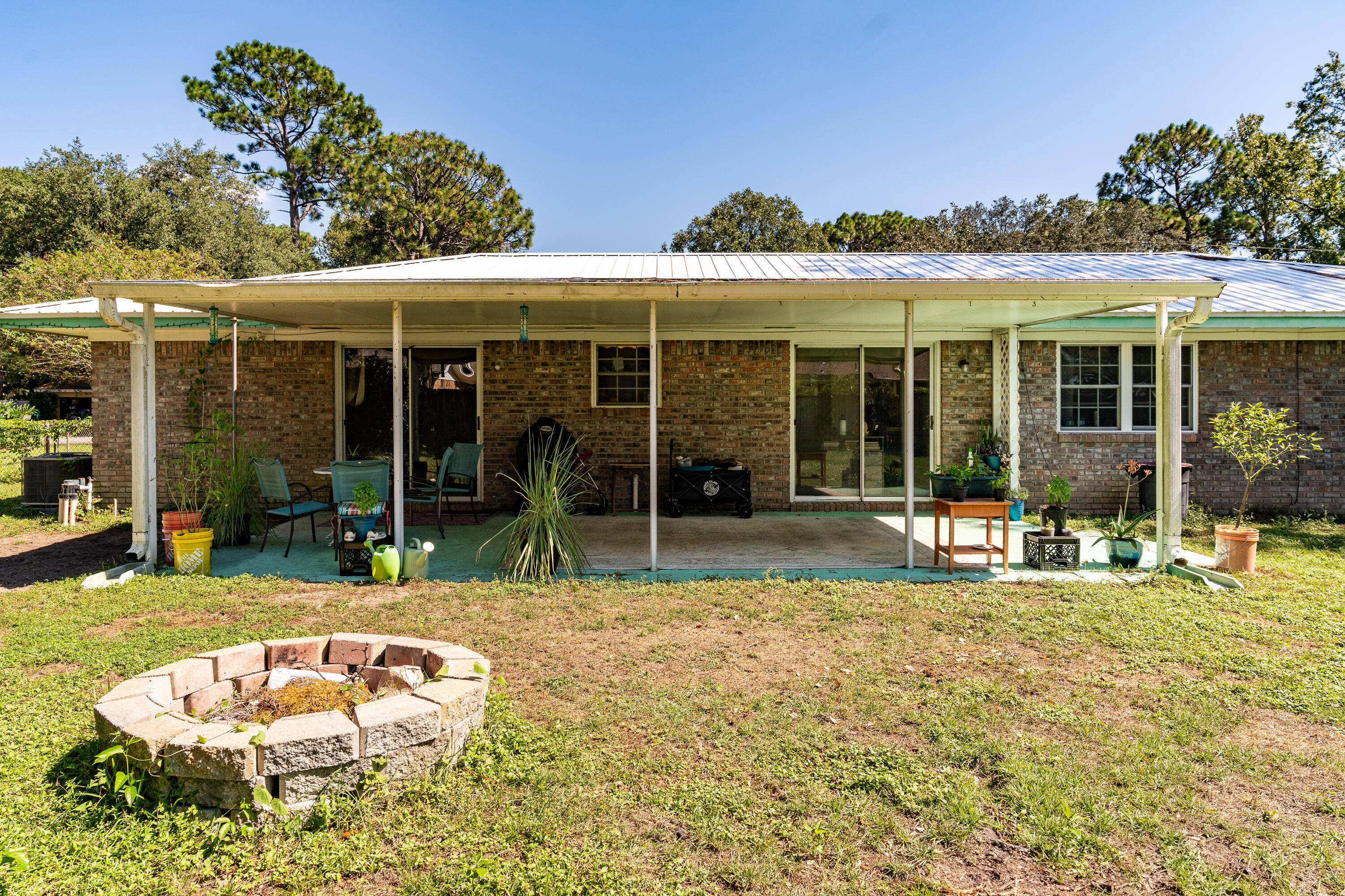 35 James Avenue Shalimar, FL 32579 - Photo 32 of 44 a view of a white house with a swimming pool and a yard