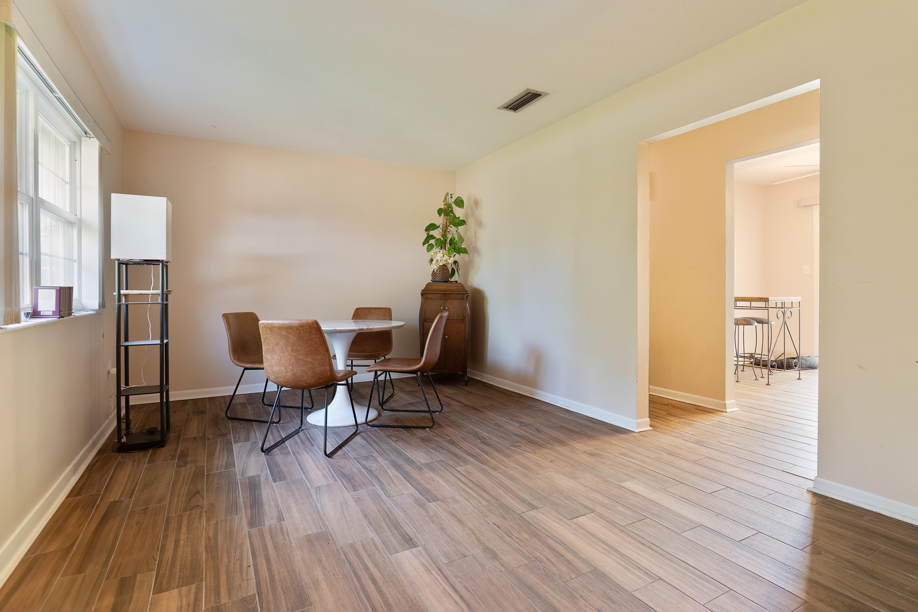35 James Avenue Shalimar, FL 32579 - Photo 4 of 44 a workspace room with wooden floor furniture and a window
