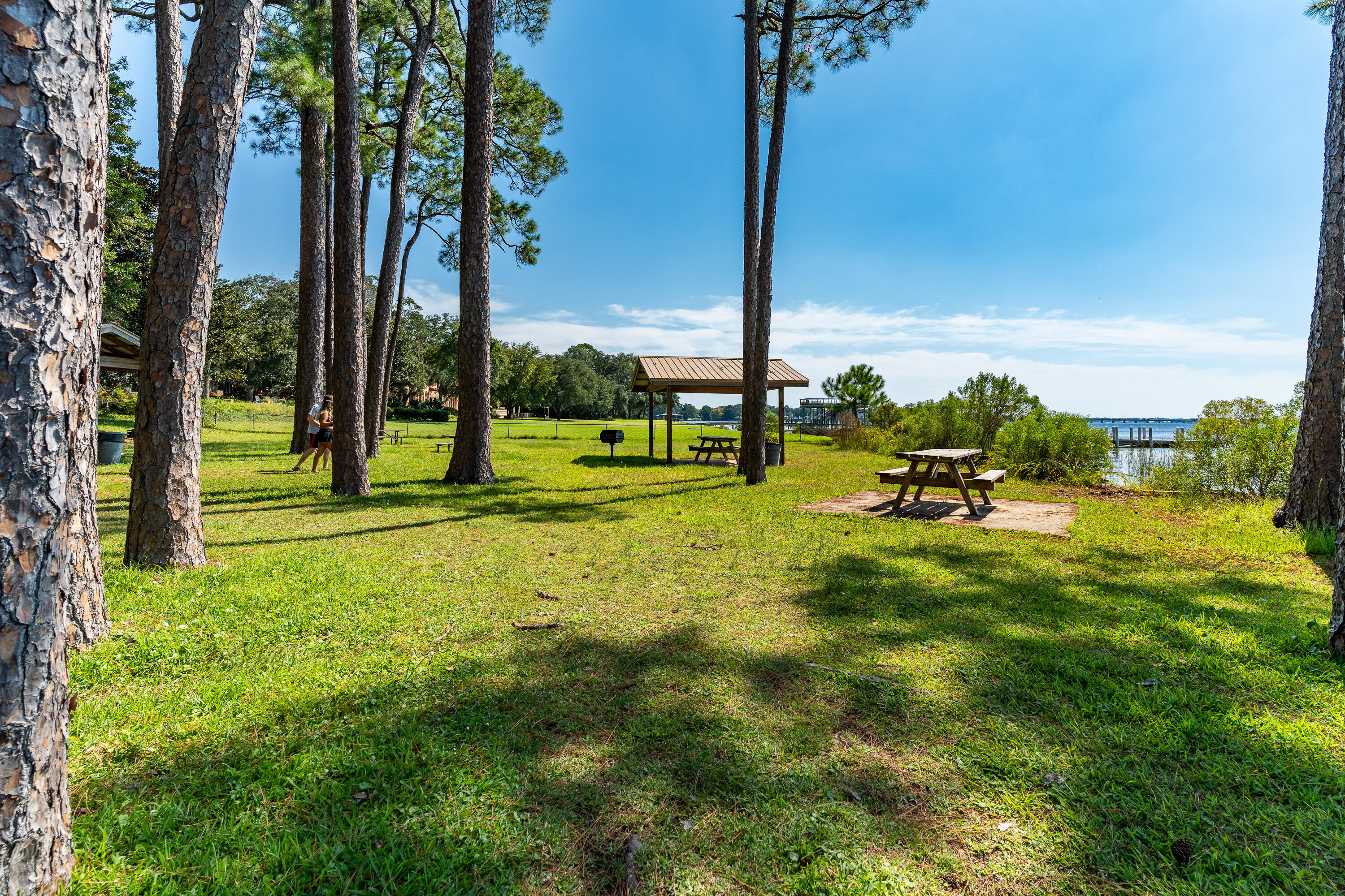 35 James Avenue Shalimar, FL 32579 - Photo 42 of 44 a view of a park with swings and a palm tree