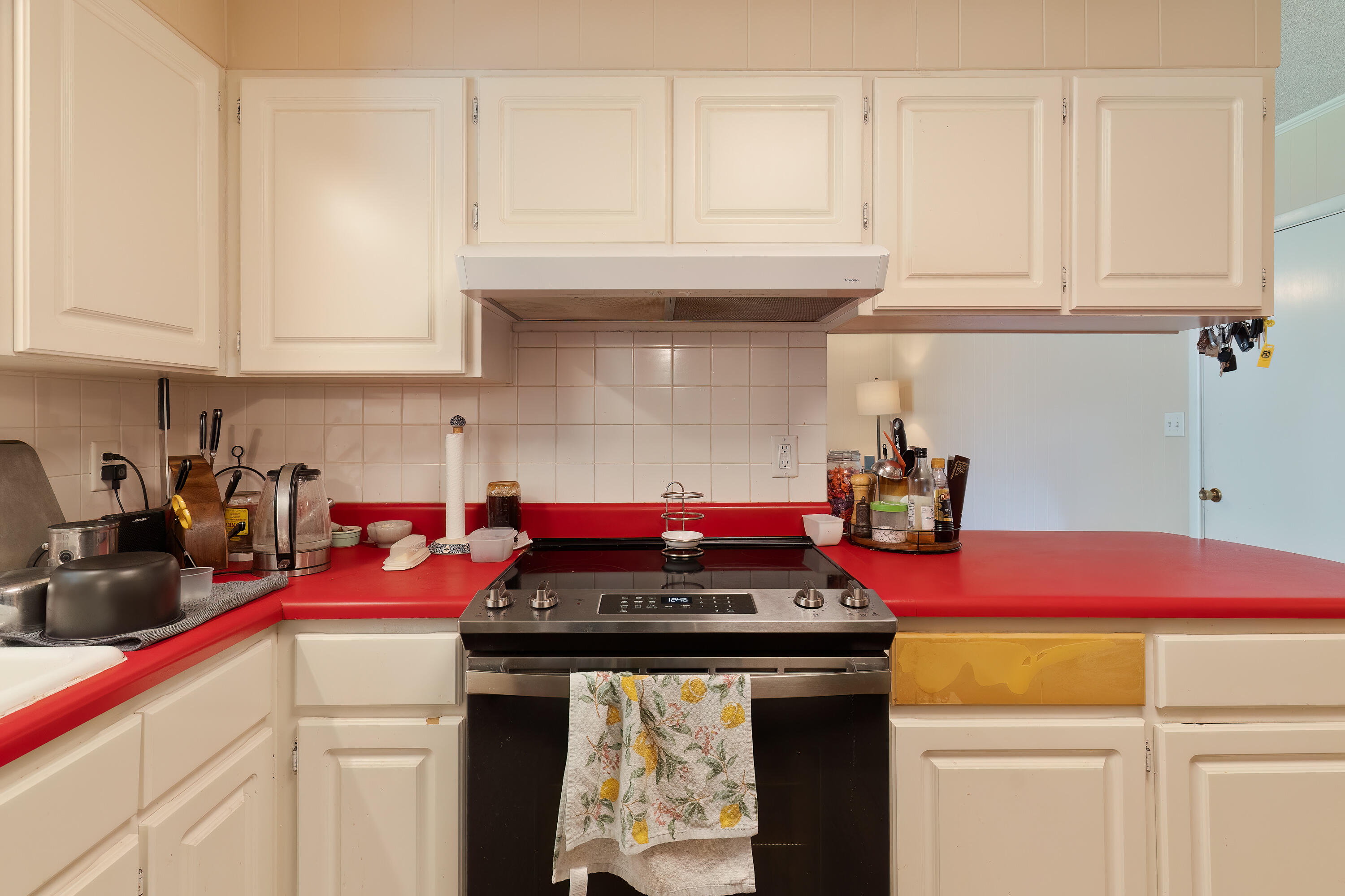 35 James Avenue Shalimar, FL 32579 - Photo 10 of 44 a kitchen with stainless steel appliances granite countertop a stove and white cabinets