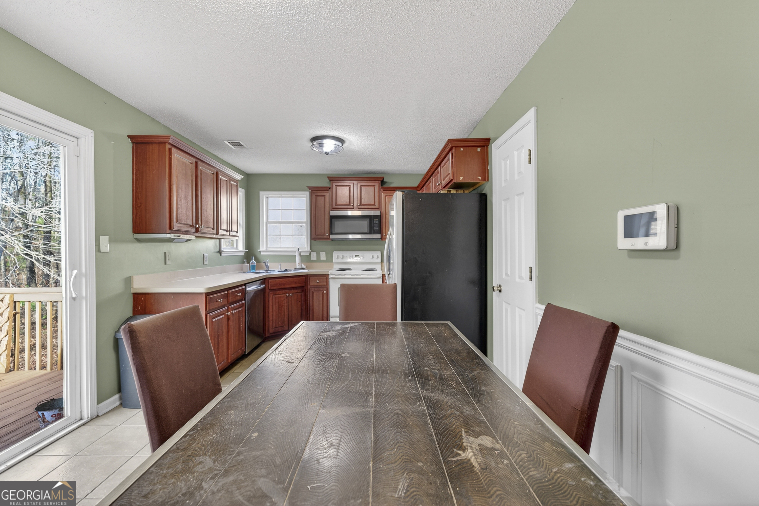 226 Amy Lane Gray, GA 31032 - Photo 14 of 46 a kitchen with stainless steel appliances granite countertop a refrigerator sink and wooden cabinets