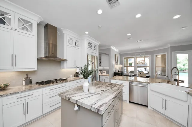 a kitchen with sink stove and cabinets