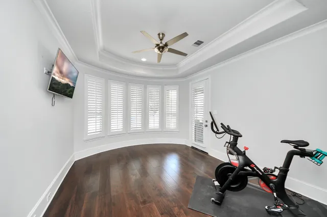 a view of a room with gym equipment and a large window