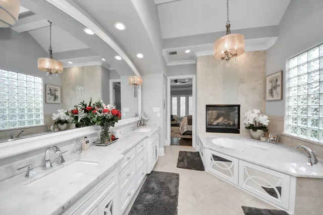 a large white kitchen with granite countertop a sink stove and refrigerator