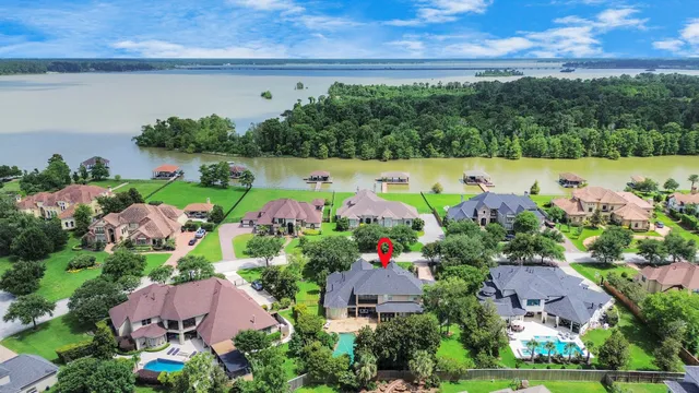 an aerial view of a house with a garden and lake view