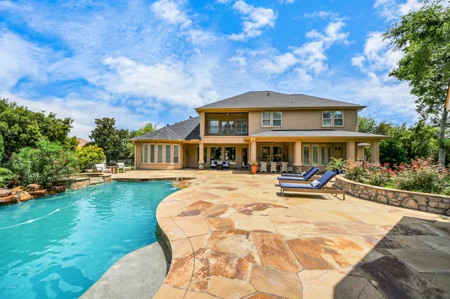 a front view of a house with swimming pool having outdoor seating