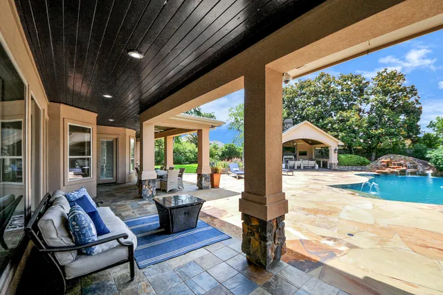 a view of a patio with table and chairs floor to ceiling window with wooden floor