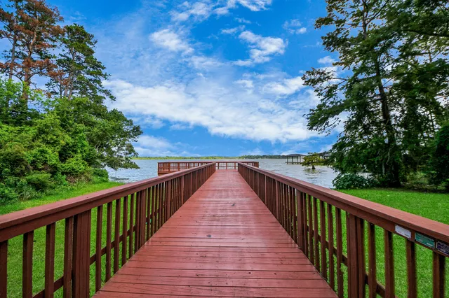 a view of a house with a big yard and large trees